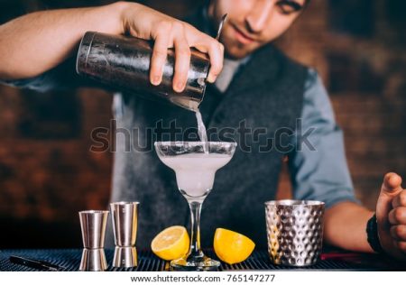 professional bartender pouring margarita cocktail 600w 765147277